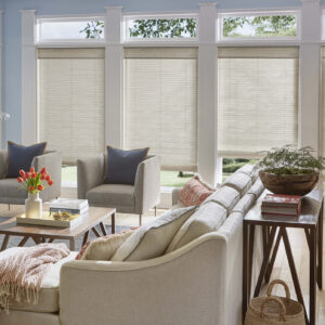 Grass weave woven shades on large living room windows in warm toned fabric