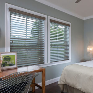 Perfect Cordless Faux Wood Blinds in Pure White installed on living room window with open slats