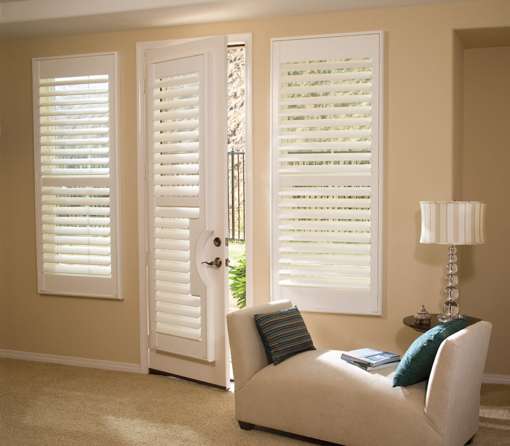 Premium painted wood plantation shutters in white finish installed on living room window