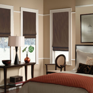 Custom flat fold roman shades in blackout fabric on bedroom windows showing smooth tailored finish