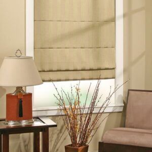 Custom plain roman shades in neutral linen fabric installed on living room windows with structured stay pocket pleats
