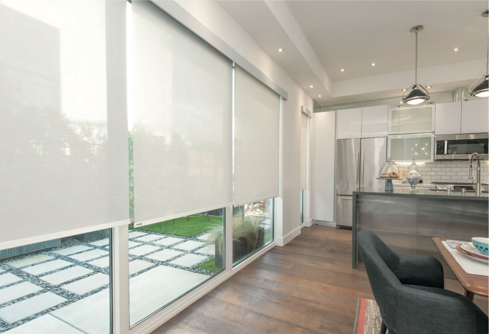 Perfect designer light filtering roller shade in Emery Creamy fabric installed on living room window