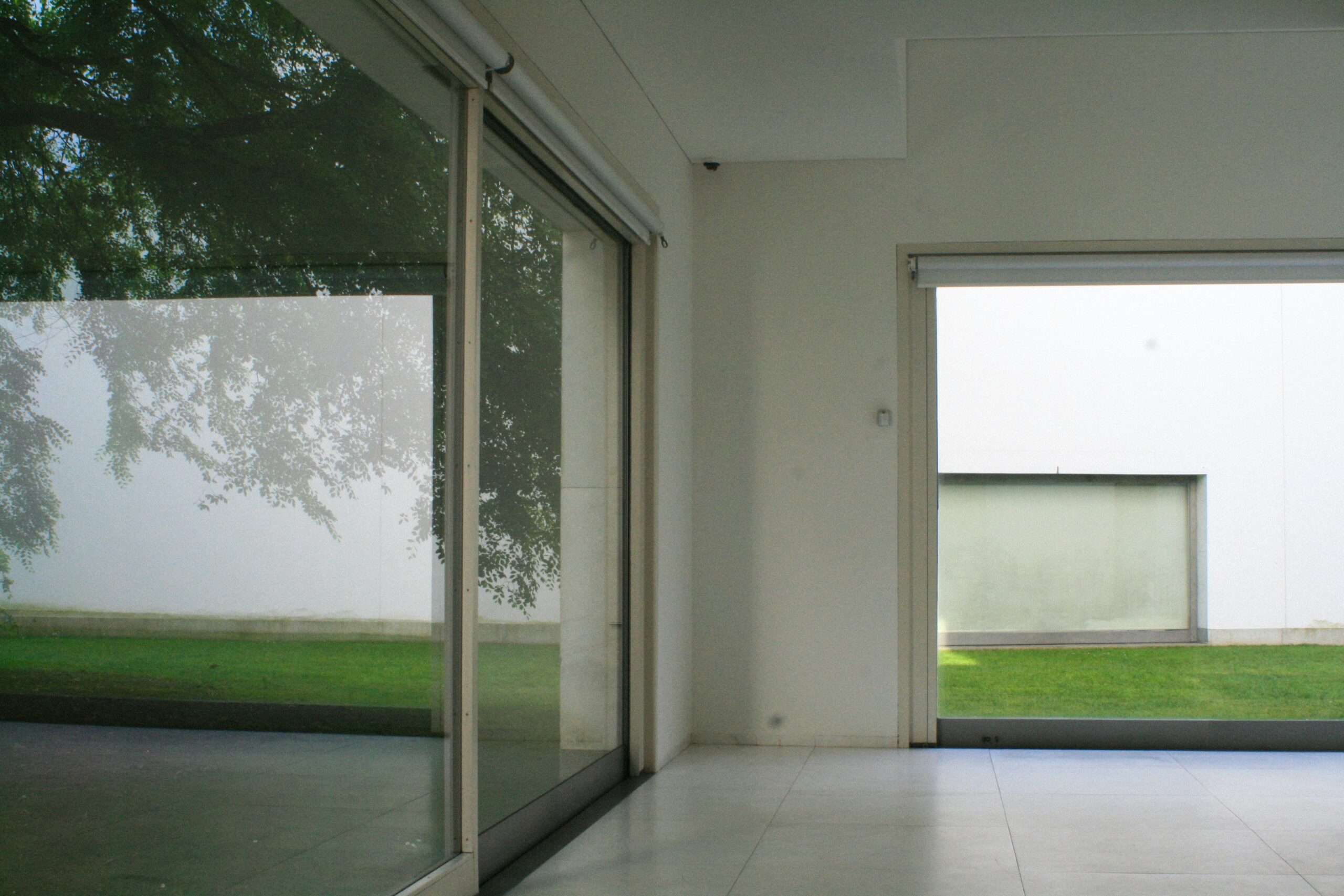 Sliding glass door installed in outdoor roller shade