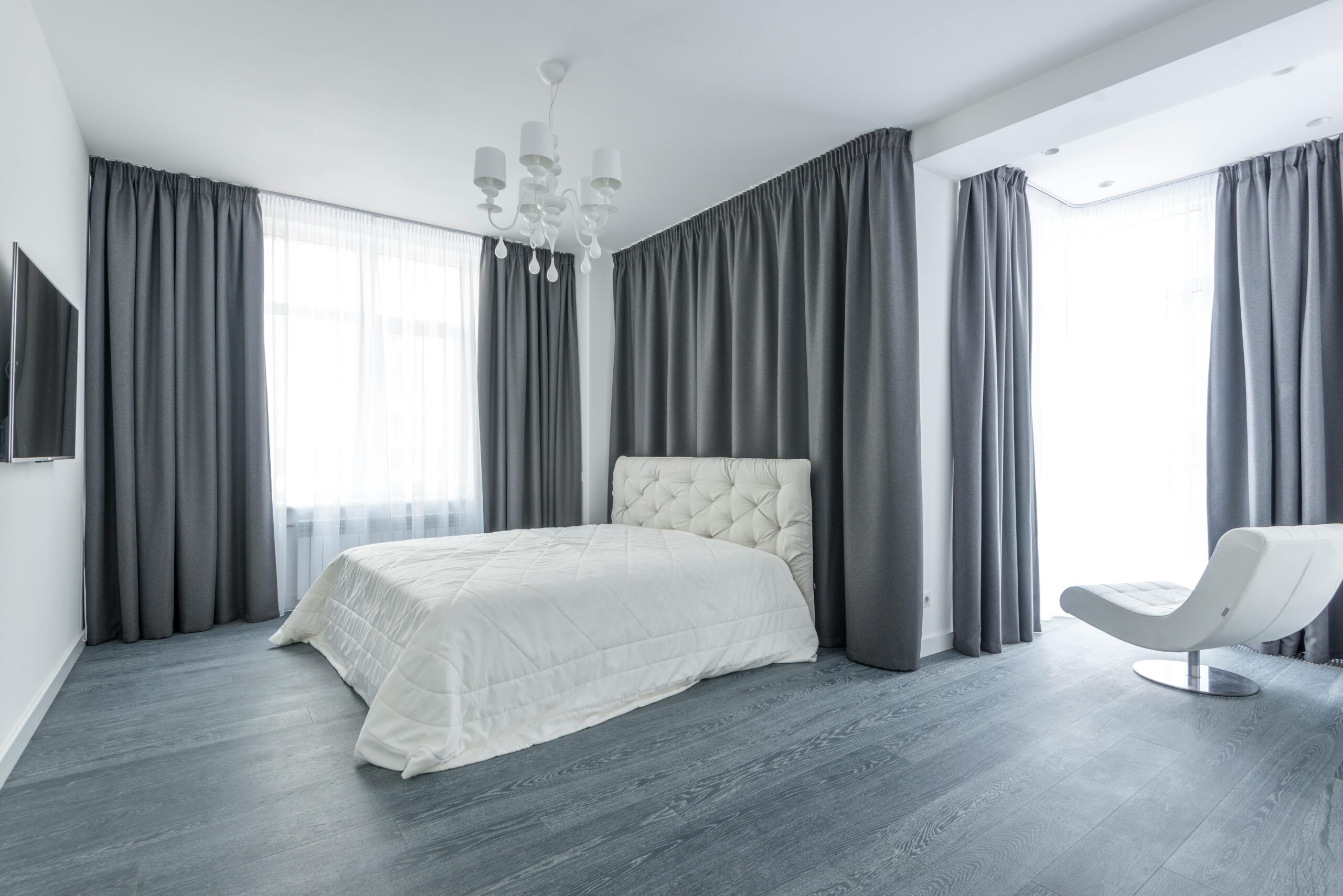 Sheer shades or curtains used in master bedroom by homeowner