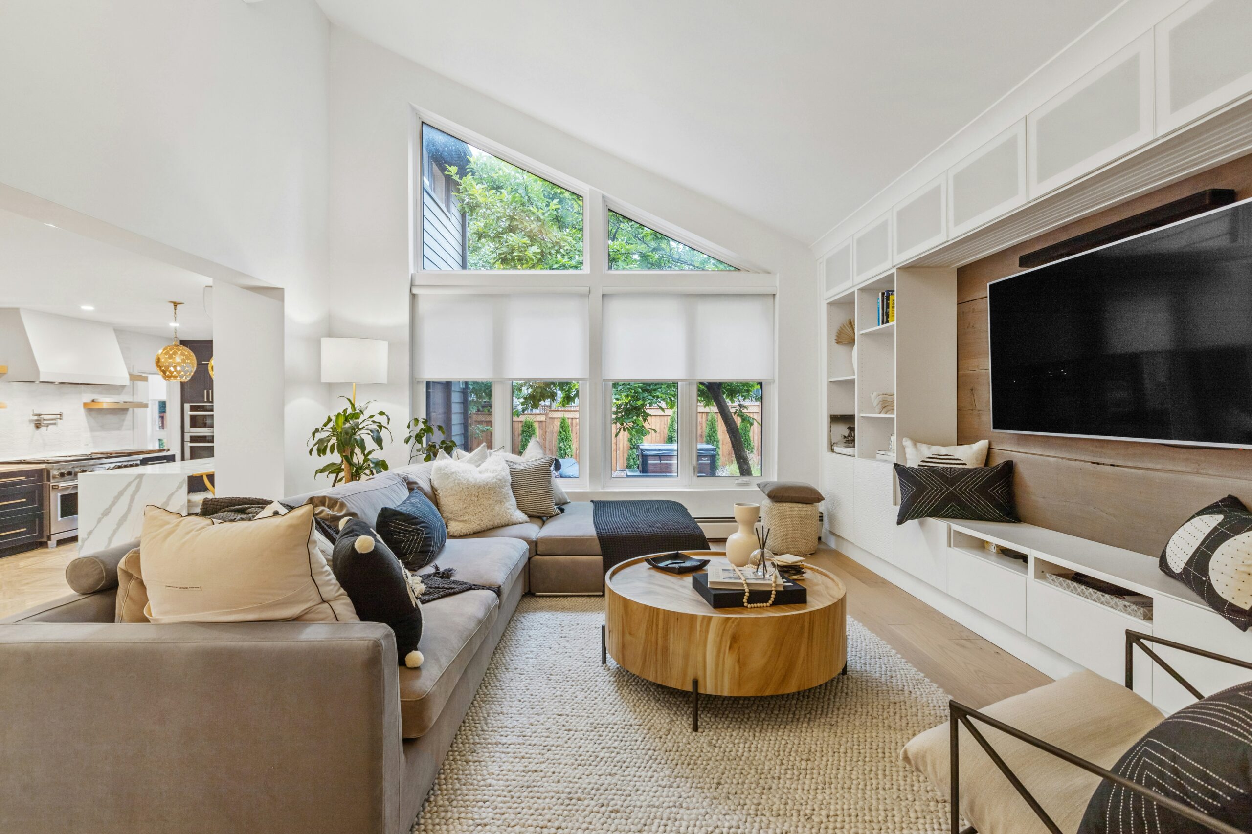 Living room having spacious and chair on floor and window have roller shades